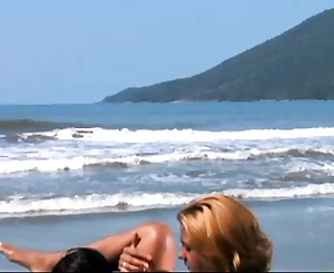 Girl/girl lovemaking on the beach for Carol Sampaio and Ane Ferrari